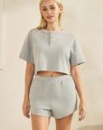 Model wearing BTTRMMT Gray Zenna Chill Set with a cropped henley top and matching ribbed shorts in a relaxed, comfy fit.