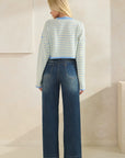 Back view of BTTRMMT Blue Rumi Pop Stripe Knit, pastel blue and yellow cropped sweater with ribbed texture and wide sleeves.