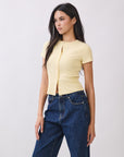 BTTRMMT Light Creme Yellow Blair Button Top side view showing slim fit, ribbed texture, and short sleeves