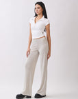 Side view of BTTRMMT Rae Wide Rib Pant in light beige, showcasing soft ribbed texture and wide-leg relaxed fit.