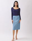 Model wearing BTTRMMT Fiona Denim Midi Skirt with front zipper and patch pockets, styled with a navy long-sleeve top.