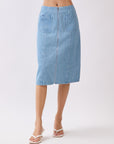 Back view of BTTRMMT Fiona Denim Midi Skirt featuring full-length back zipper and dual patch pockets in light blue denim.