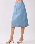 Side view of BTTRMMT Fiona Denim Midi Skirt showing its straight silhouette, clean side paneling, and mid-length denim fit.