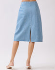 Back view of BTTRMMT Fiona Denim Midi Skirt featuring a full-length back zipper and two patch pockets in light blue denim.