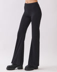 Side view of BTTRMMT Calista Fit Flare Pants in black featuring a smooth waistband, stretchy fit, and sleek flared leg silhouette.
