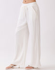 Side view of BTTRMMT Ivory Yuna Soft Wide Leg Pants featuring a flowy drape, elastic waistband, and relaxed lightweight fit.
