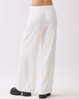 Back view of BTTRMMT Ivory Calia Pants featuring a relaxed wide-leg fit and soft draped silhouette.