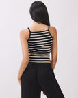 BTTRMMT Ivory and Black Striped Ribbed Tank Top โ back view showing fitted ribbed texture and cropped hem with denim mini skirt.