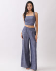 Model wearing BTTRMMT Denim Olivyn Set in blue with a square-neck cropped top and matching high-waist wide-leg pants.