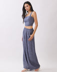 Side view of model wearing BTTRMMT Denim Olivyn Set in blue, featuring a square-neck cropped top and matching high-waist wide-leg pants.
