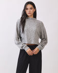 Model wearing the BTTRMMT Elina High Neck Sweater in heather gray, a soft cropped knit with long sleeves and a relaxed fit.