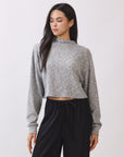 Model wearing the BTTRMMT Elina High Neck Sweater in heather gray, a soft cropped knit with long sleeves and a relaxed fit.