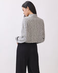 Back view of model wearing the BTTRMMT Elina High Neck Sweater, featuring a soft gray knit and relaxed cropped fit.