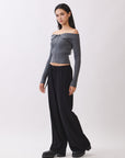Side view of model wearing the BTTRMMT Camille Zip Knit in charcoal gray, showing the off-shoulder ribbed fit and cropped silhouette.