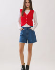 BTTRMMT Rhea Knit Vest front view featuring red button-front knit vest layered over long sleeve top