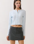 BTTRMMT Blue Sophie Ribbed Button Cardigan front view, cropped ribbed knit cardigan styled with charcoal mini skirt.