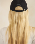 BTTRMMT black Los Angeles cap shown from the back, featuring adjustable strap detail and a clean minimal streetwear look