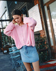 BTTRMMT Pink Millie Cardigan front view worn in downtown Los Angeles with button-front design and relaxed cozy fit