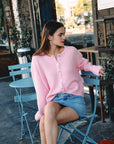 BTTRMMT Pink Millie Cardigan front view worn in downtown Los Angeles with button-front design and relaxed cozy fit