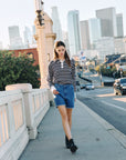 BTTRMMT Rae High Rise Denim Shorts styled with a striped top while walking in downtown Los Angeles