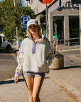 BTTRMMT Softline Fleece Pullover styled casually with shorts in a downtown Los Angeles street setting