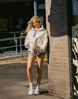 BTTRMMT Softline Fleece Pullover styled casually with shorts in a downtown Los Angeles street setting