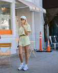 BTTRMMT Yellow Zenna Short Sleeve Top styled on model in downtown Los Angeles street