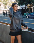 BTTRMMT Reese Studded Hoodie styled on model in downtown Los Angeles street