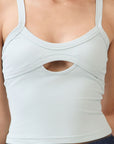 Close up view of model wearing BTTRMMT mint cutout tank top with scoop neckline, showing fabric details.