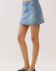 BTTRMMT Tate Everyday Denim Skirt side view highlighting straight silhouette and mini length