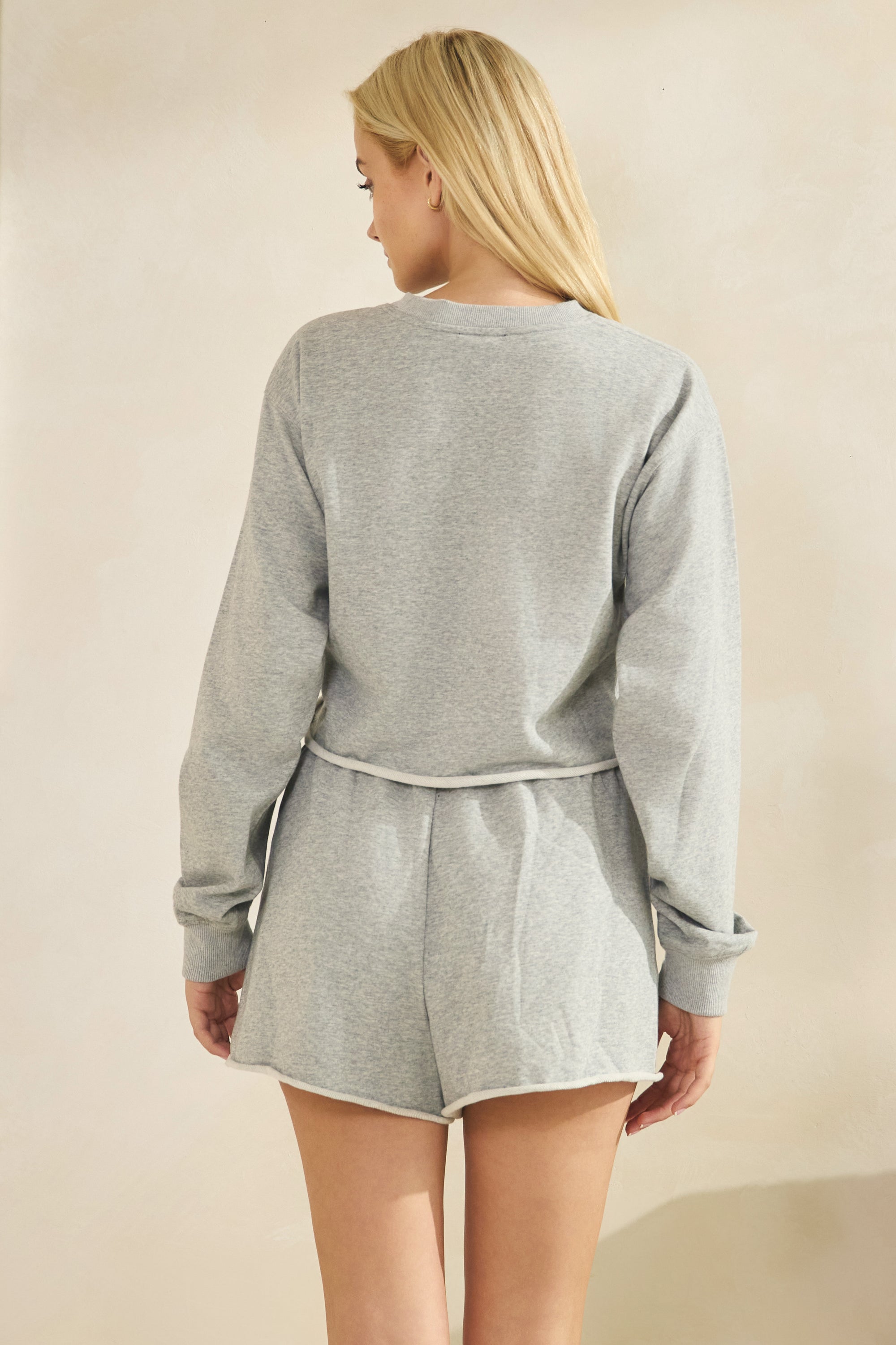 Back view of the BTTRMMT Gray Sweet Easy Sweatshirt showcasing the relaxed cropped fit, long sleeves, and soft heather gray fabric.