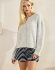 Model wearing BTTRMMT Gray Millie Cardigan paired with navy striped shorts, showcasing a soft, cozy, oversized knit look.