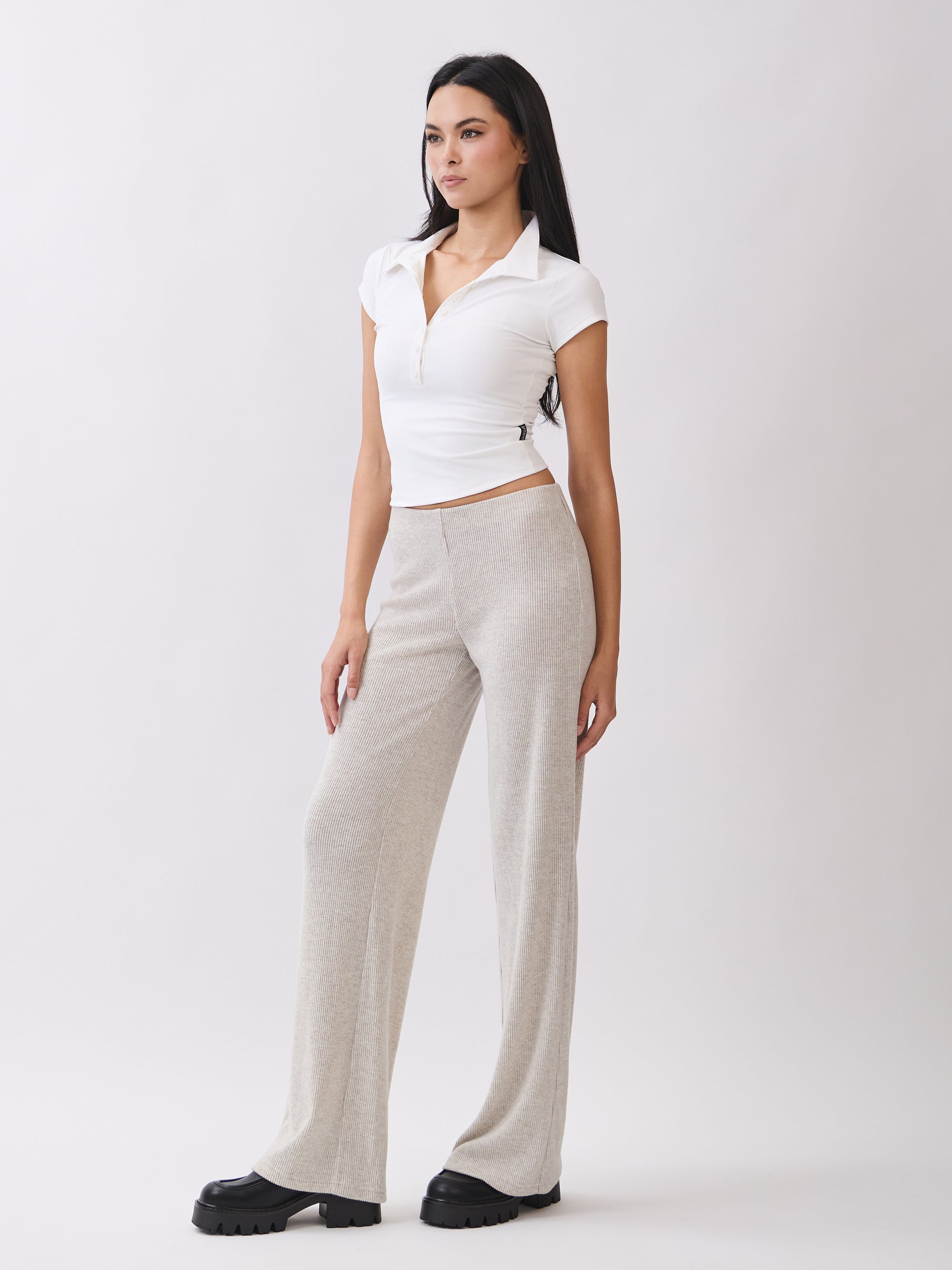 Side view of BTTRMMT Rae Wide Rib Pant in light beige, showcasing soft ribbed texture and wide-leg relaxed fit.