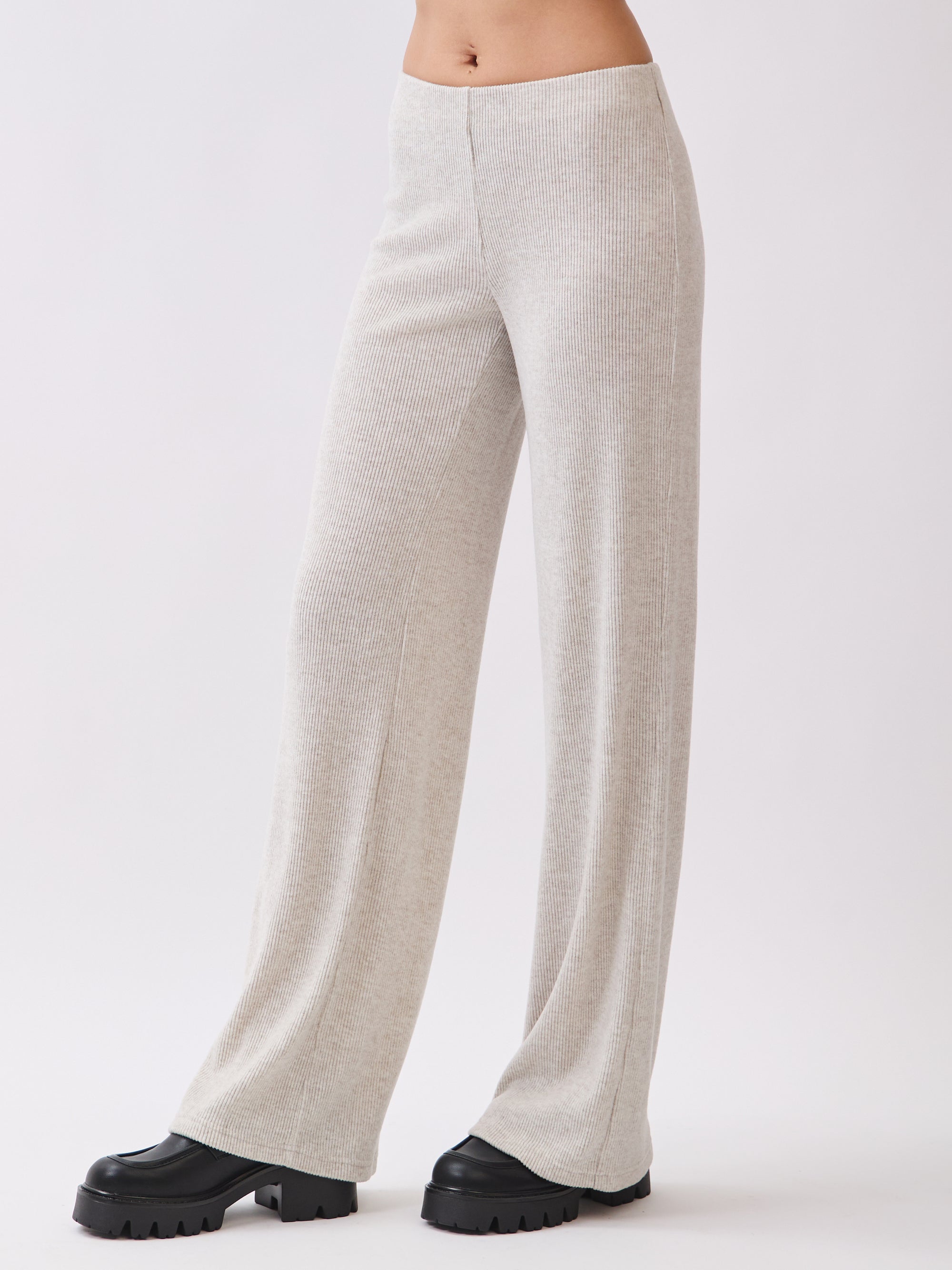 Side view of BTTRMMT Rae Wide Rib Pant in light beige, showing relaxed wide-leg fit and ribbed knit texture.