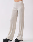 Side view of BTTRMMT Rae Wide Rib Pant in light beige, showing relaxed wide-leg fit and ribbed knit texture.