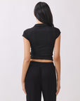 Back view of the BTTRMMT Black Eliza Fitted Polo Top, showing its slim stretch fit, cap sleeves, and clean, minimal everyday style.