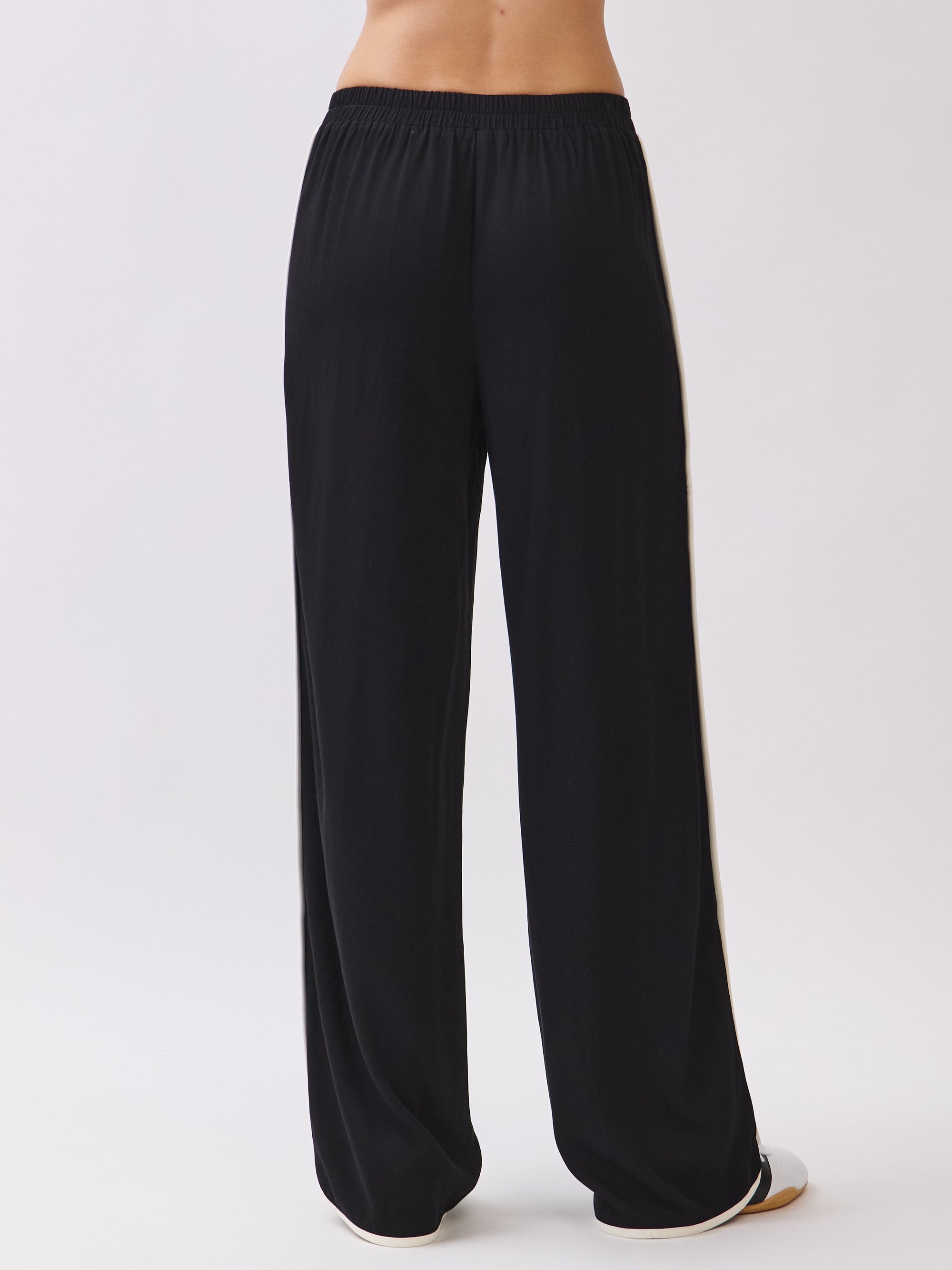 Back view of the Nova Contrast Trim Pants in black featuring elastic waistband and relaxed straight-leg fit.