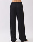 Back view of the Nova Contrast Trim Pants in black featuring elastic waistband and relaxed straight-leg fit.