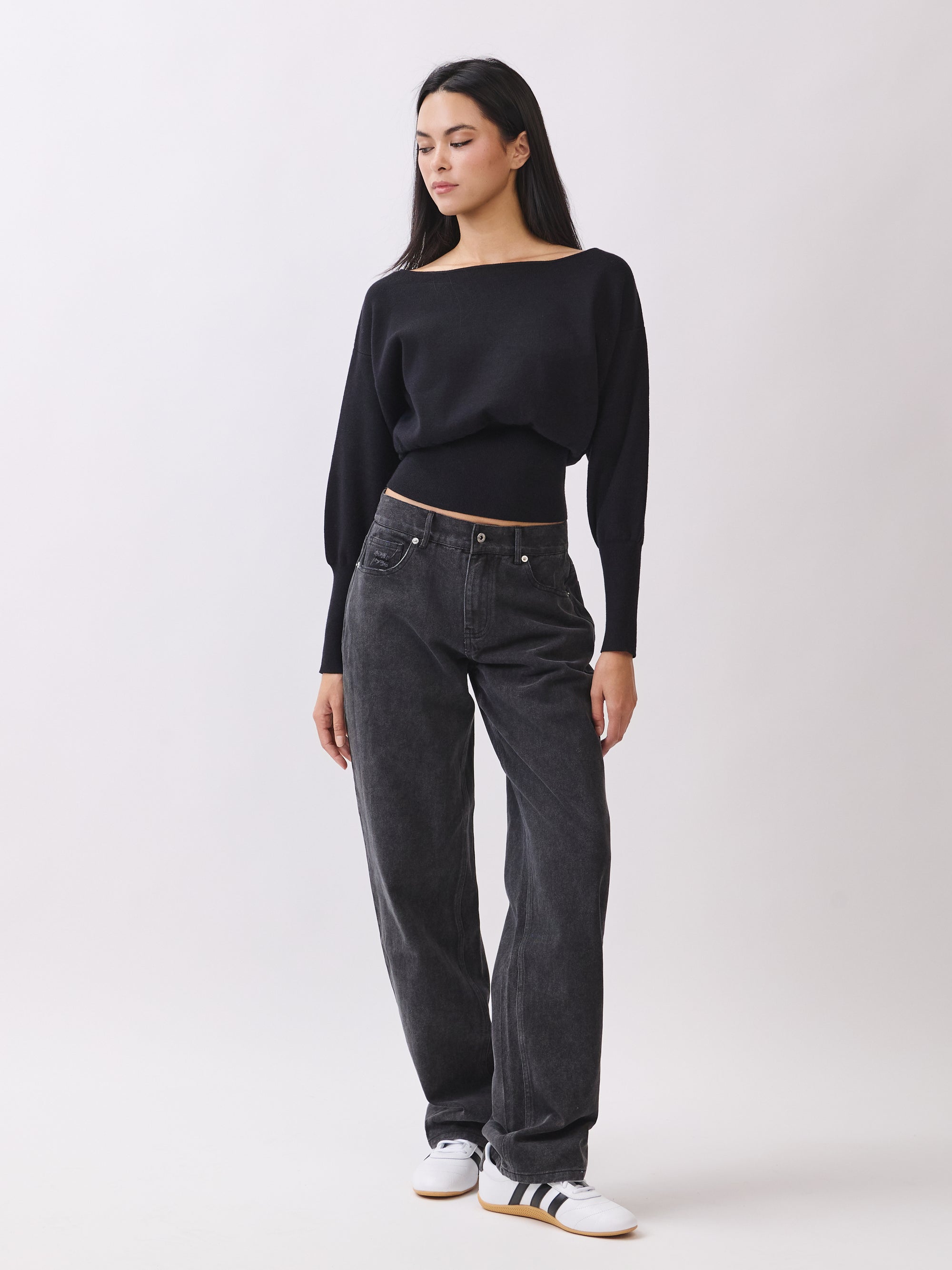 Side view of BTTRMMT Black Tessa Boatneck Sweater, relaxed off-shoulder knit with ribbed waist.