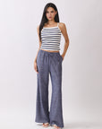 Front view of model wearing BTTRMMT Denim Calia Pants styled with a striped knit tank, featuring a relaxed wide-leg fit and drawstring waist.