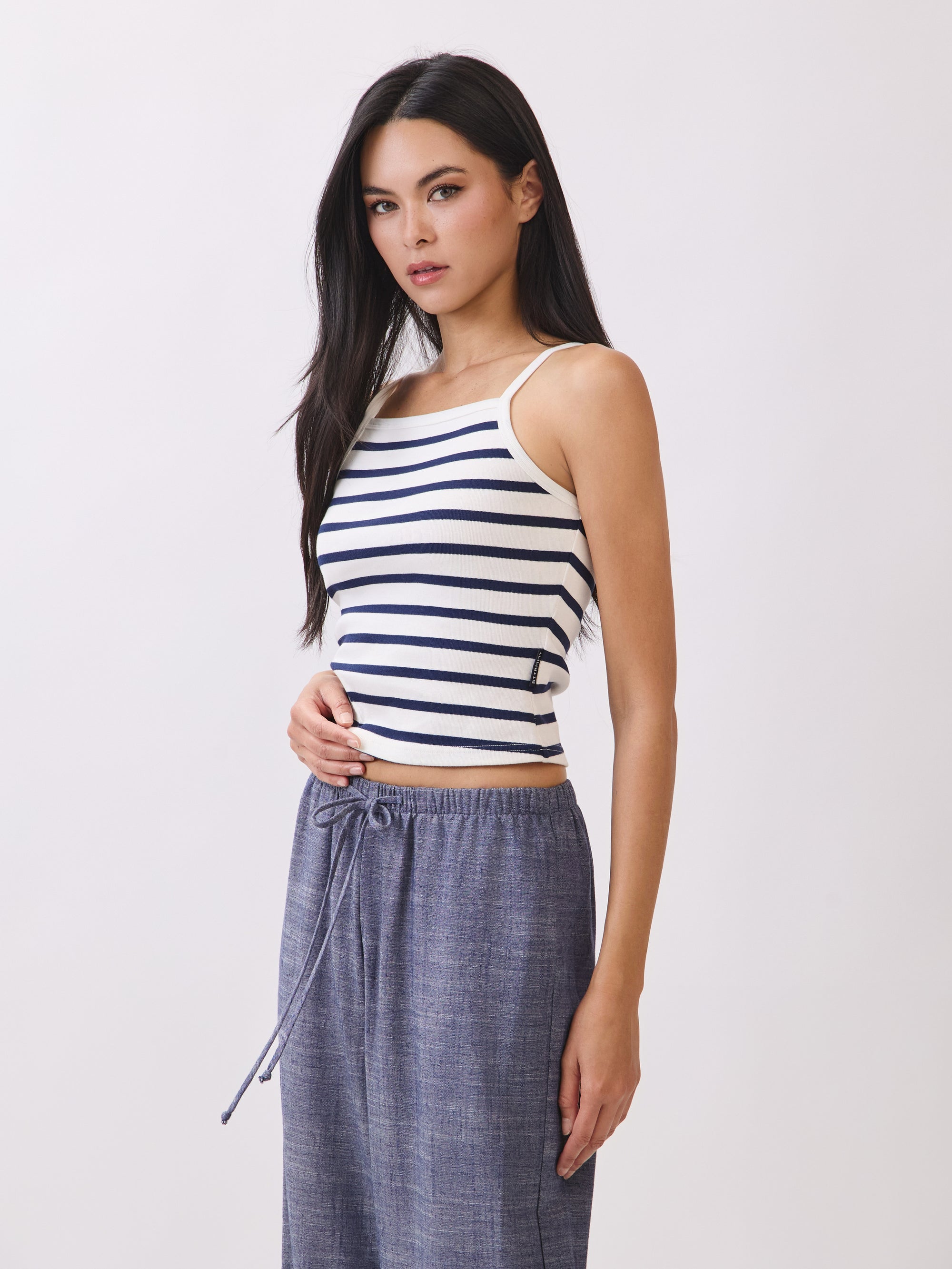 Side view of BTTRMMT Ivory and Navy Striped Ribbed Tank Top featuring square neckline and fitted silhouette.
