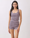 Close-up of model wearing BTTRMMT Aurora Soft Stripe Set, ribbed pink and navy tank romper with scoop neckline.