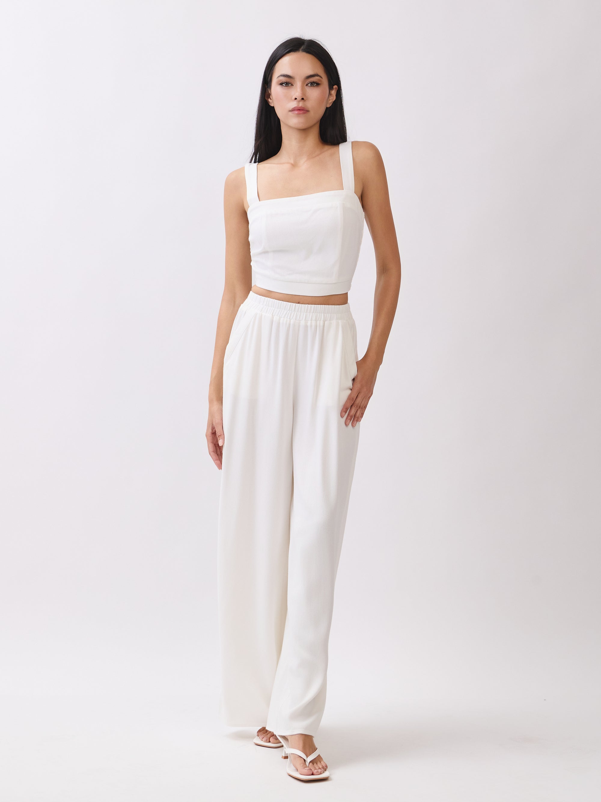 Model wearing BTTRMMT Ivory Olivyn Set featuring a cropped square-neck top and matching high-waisted wide-leg pants.
