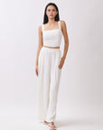 Model wearing BTTRMMT Ivory Olivyn Set featuring a cropped square-neck top and matching high-waisted wide-leg pants.