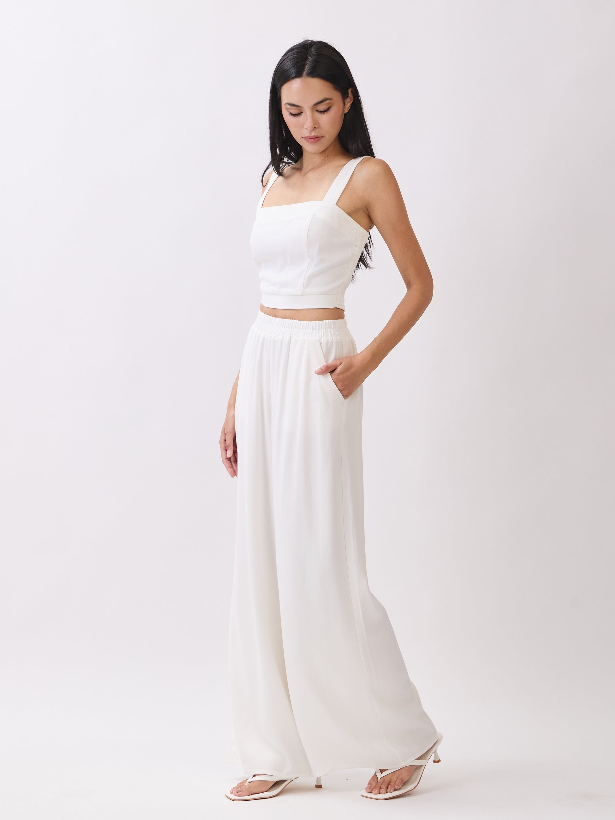 Side view of BTTRMMT Ivory Olivyn Set showing cropped square-neck top and flowy high-waisted wide-leg pants.
