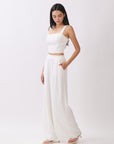 Side view of BTTRMMT Ivory Olivyn Set showing cropped square-neck top and flowy high-waisted wide-leg pants.
