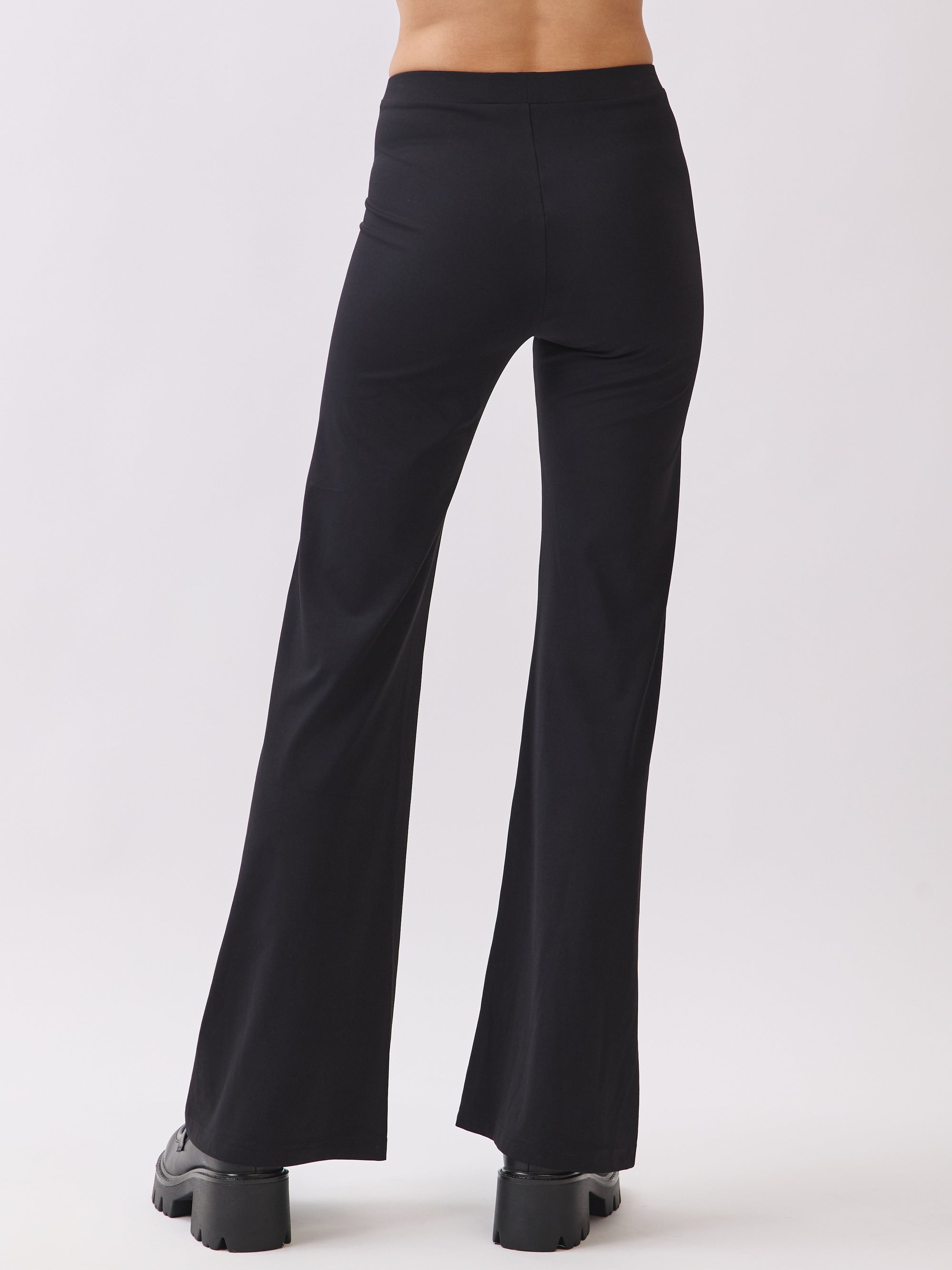 Back view of BTTRMMT Calista Fit Flare Pants in black with a smooth waistband, soft stretch fabric, and clean flared leg shape.