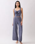 Model wearing BTTRMMT The Delilah Set, blue textured two-piece with tie-front crop top and matching wide-leg pants.