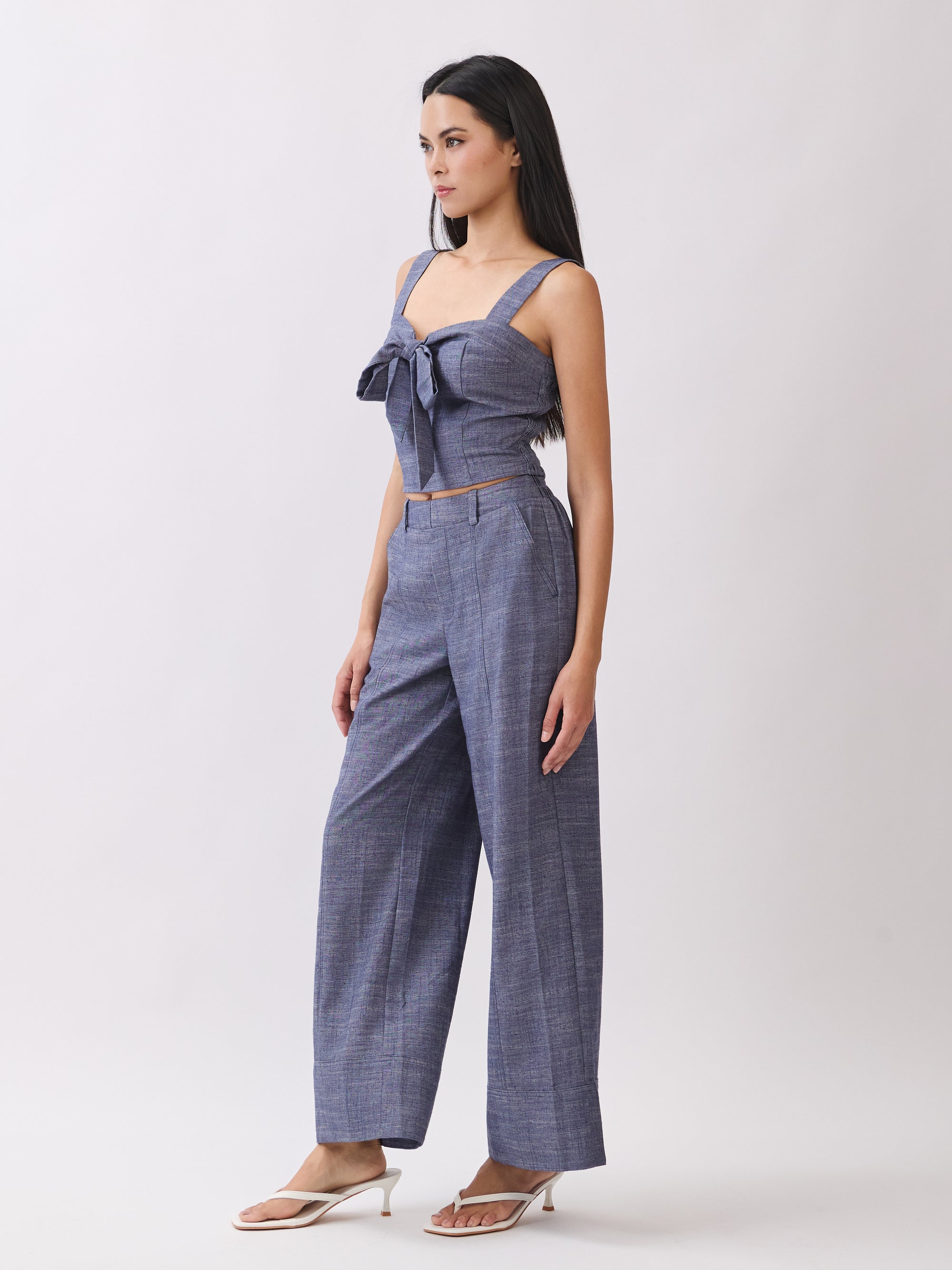 Side view of BTTRMMT The Delilah Set, blue textured two-piece featuring a tie-front crop top and flowy wide-leg pants.