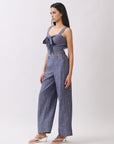 Side view of BTTRMMT The Delilah Set, blue textured two-piece featuring a tie-front crop top and flowy wide-leg pants.